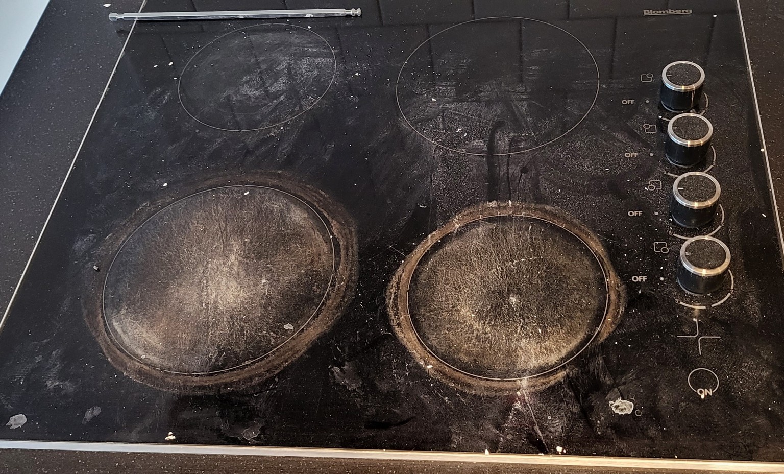 Electric stovetop before cleaning with grease and buildup
